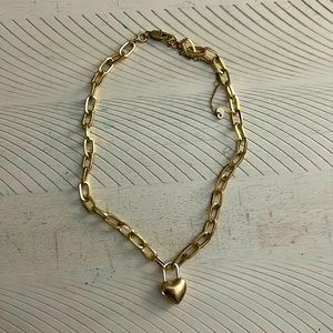Golden heart lock necklace on a thick chain